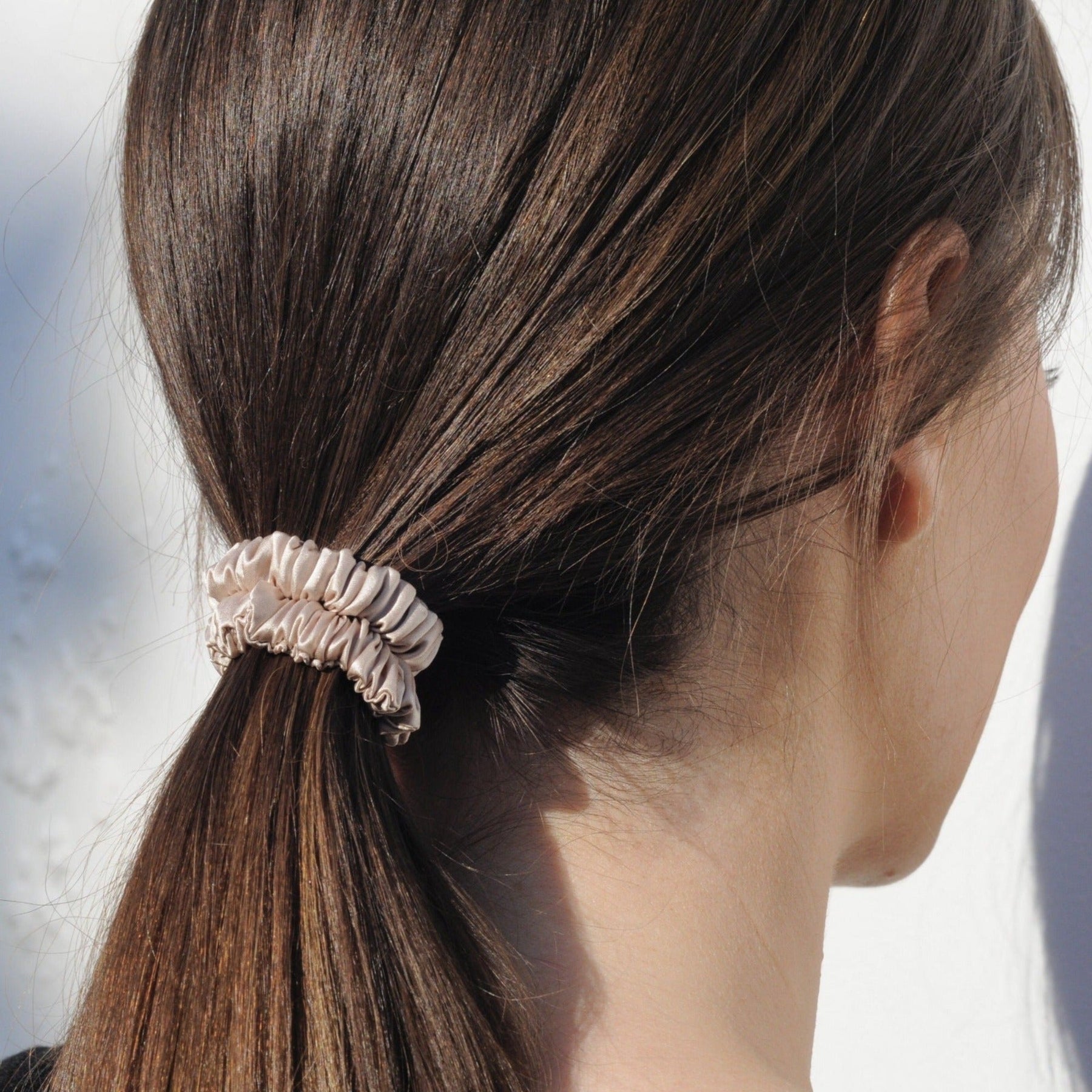 lady with skinny caramel silk scrunchie in hair