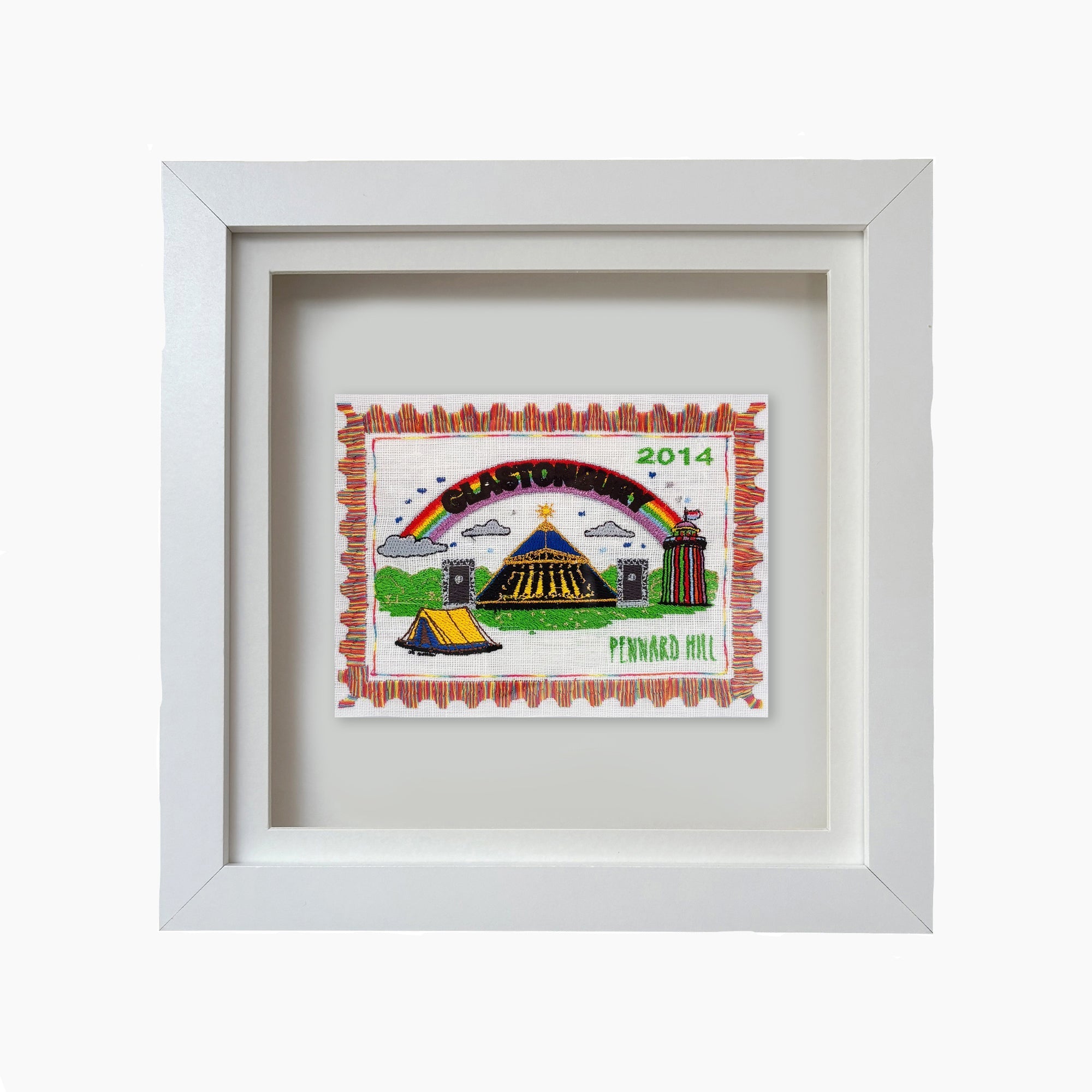 Framed artwork with a colorful design featuring a rainbow, tents, and text on a white background