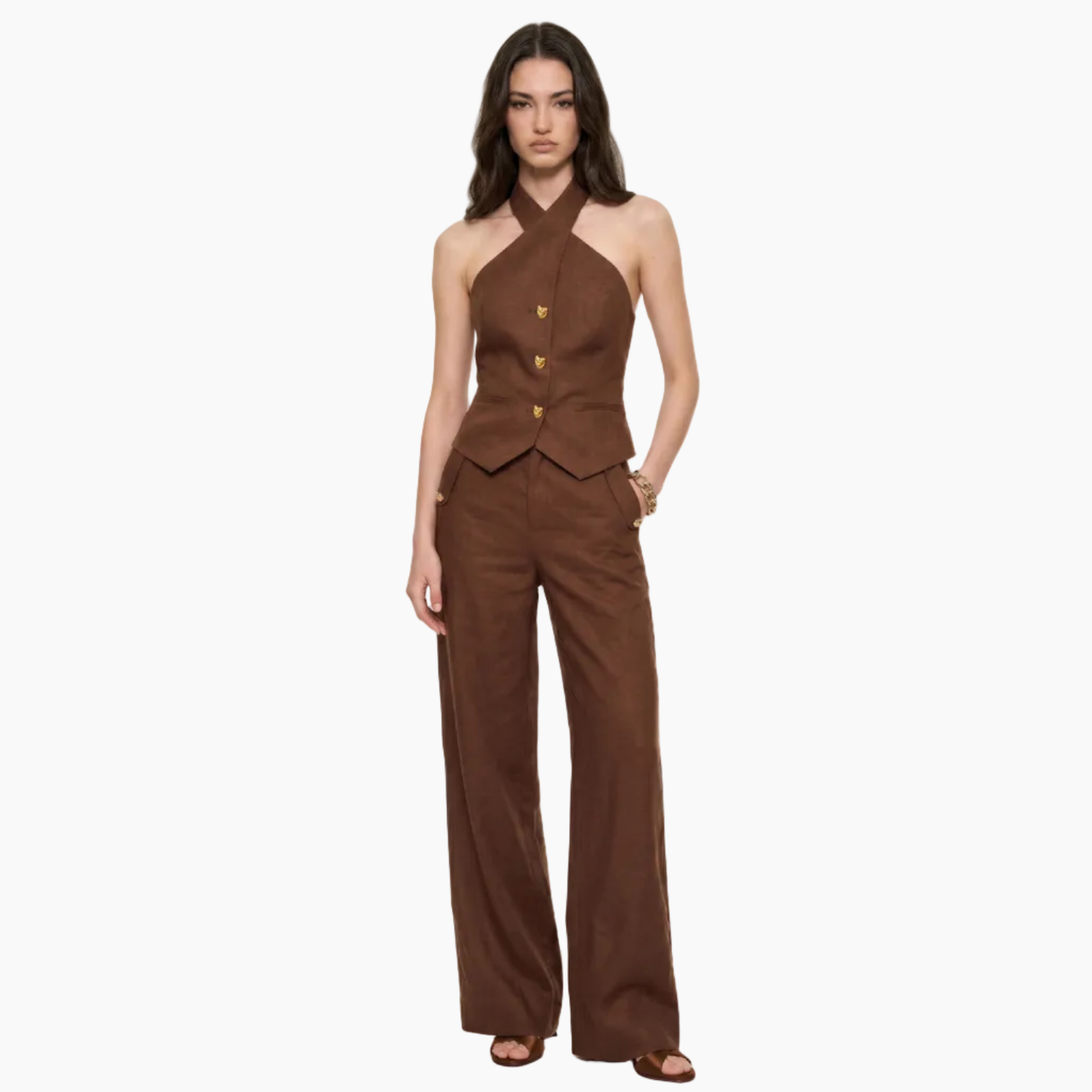 Woman wearing a brown jumpsuit on a white background