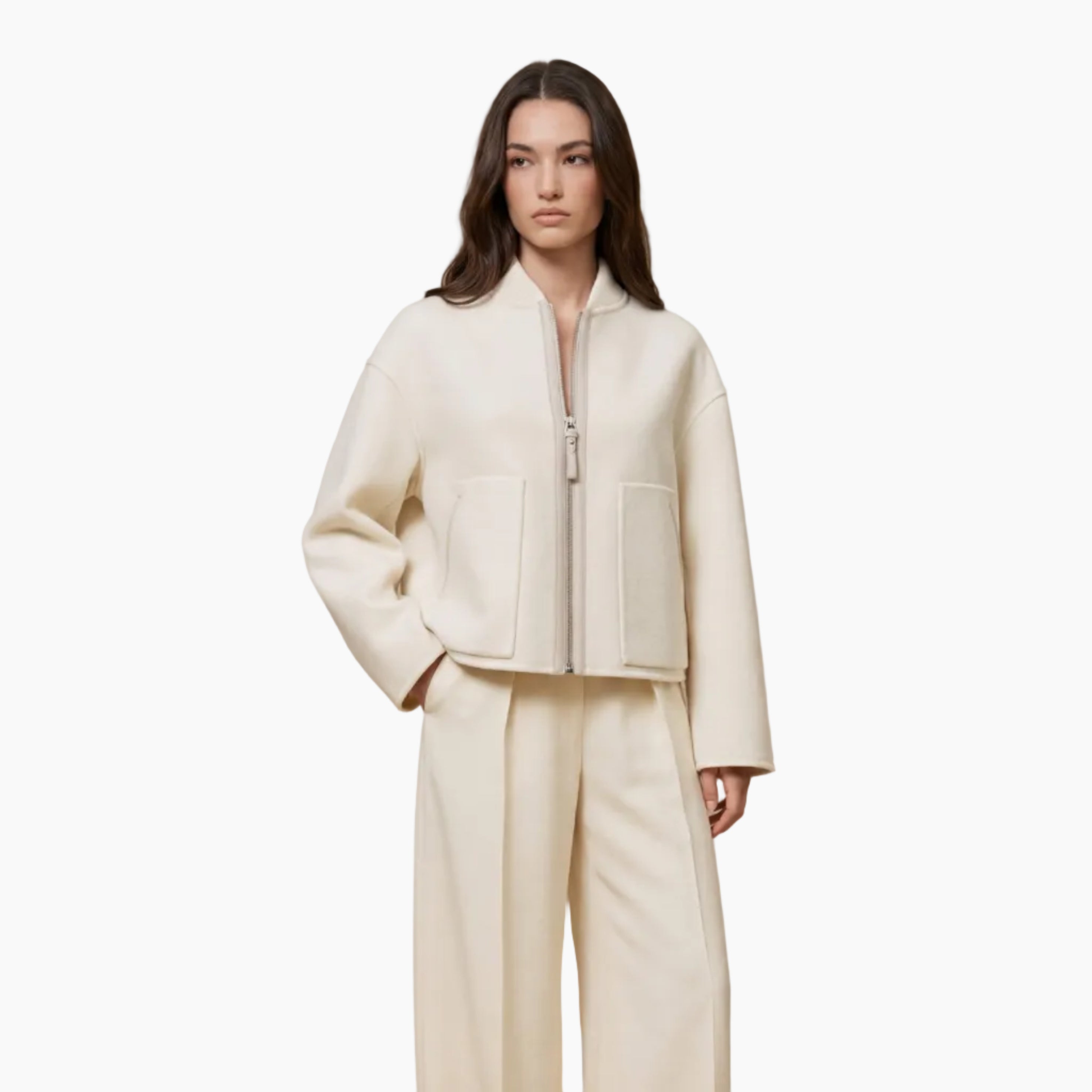 Woman wearing a cream-colored outfit on a beige background