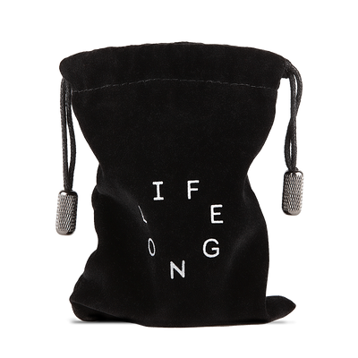 Black travel bag for refillable deodorant  from the brand Lifelongdeo. Bag is velvet with a circle white logo saying Lifelong. The straps has knurled metal details in the ends. 