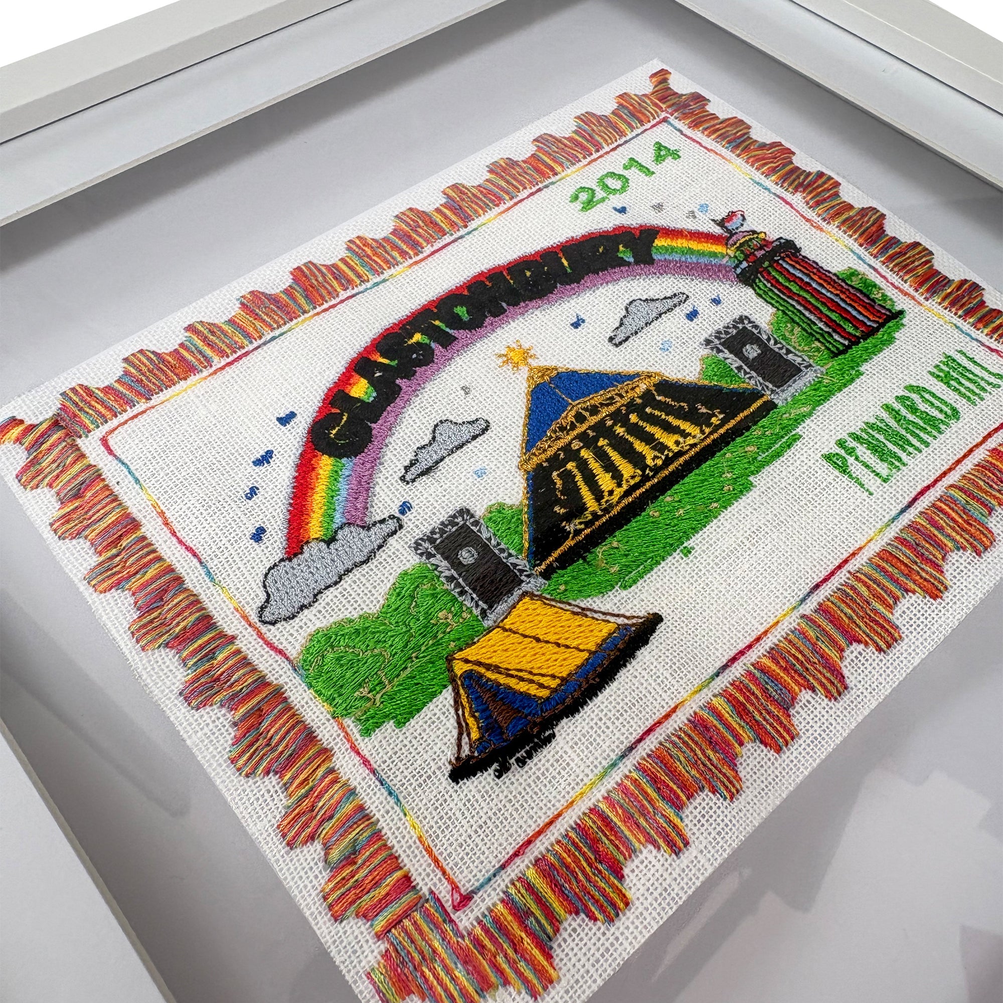 Embroidered artwork with rainbow, castle, and text on a white background