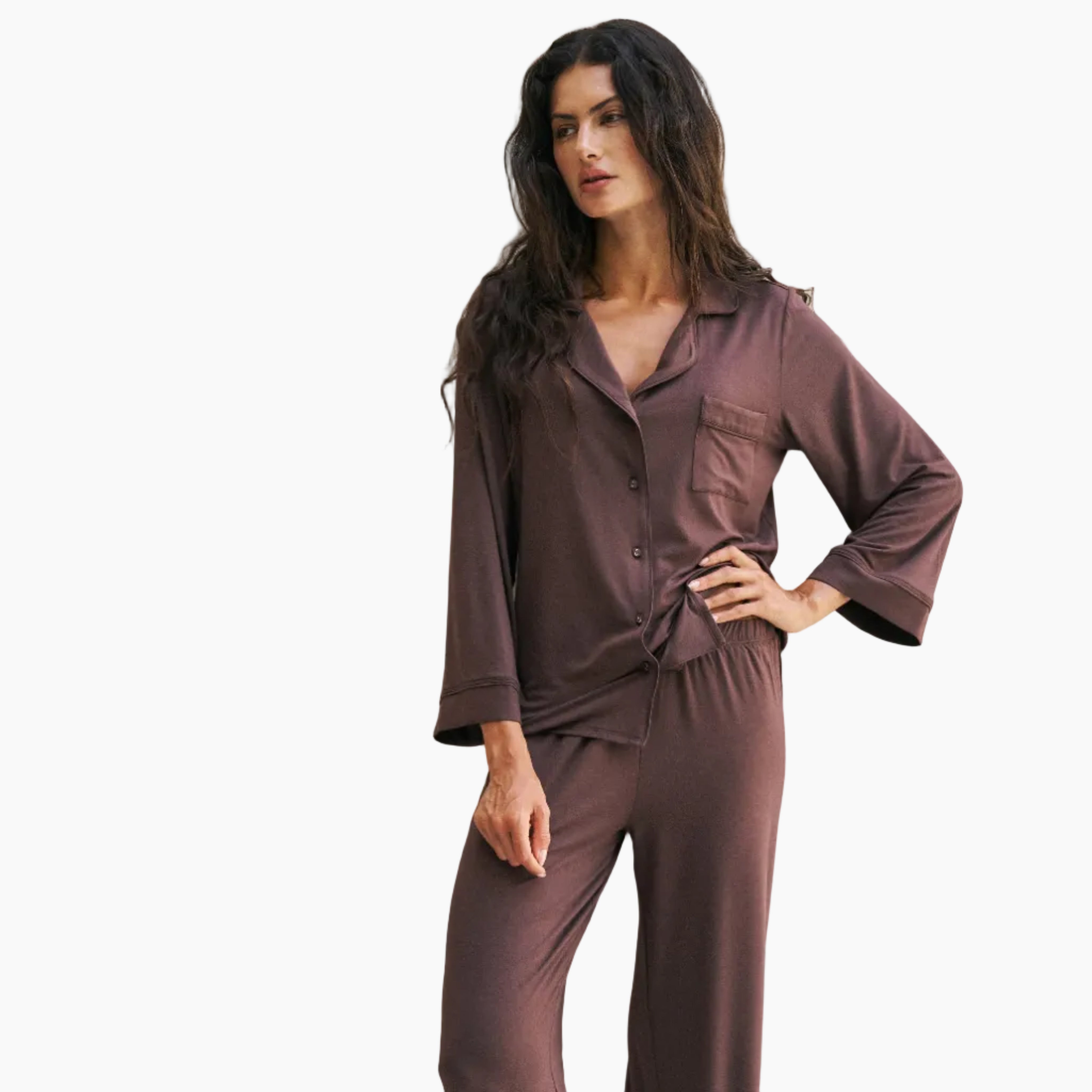 Woman wearing a brown pajama set against a white background