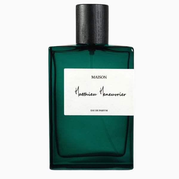Green perfume bottle with a white label on a white background