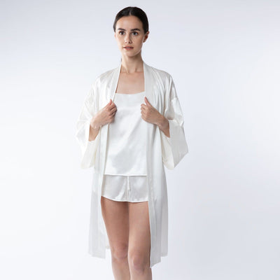 Lady wearing silk ivory shorts, camisole and robe