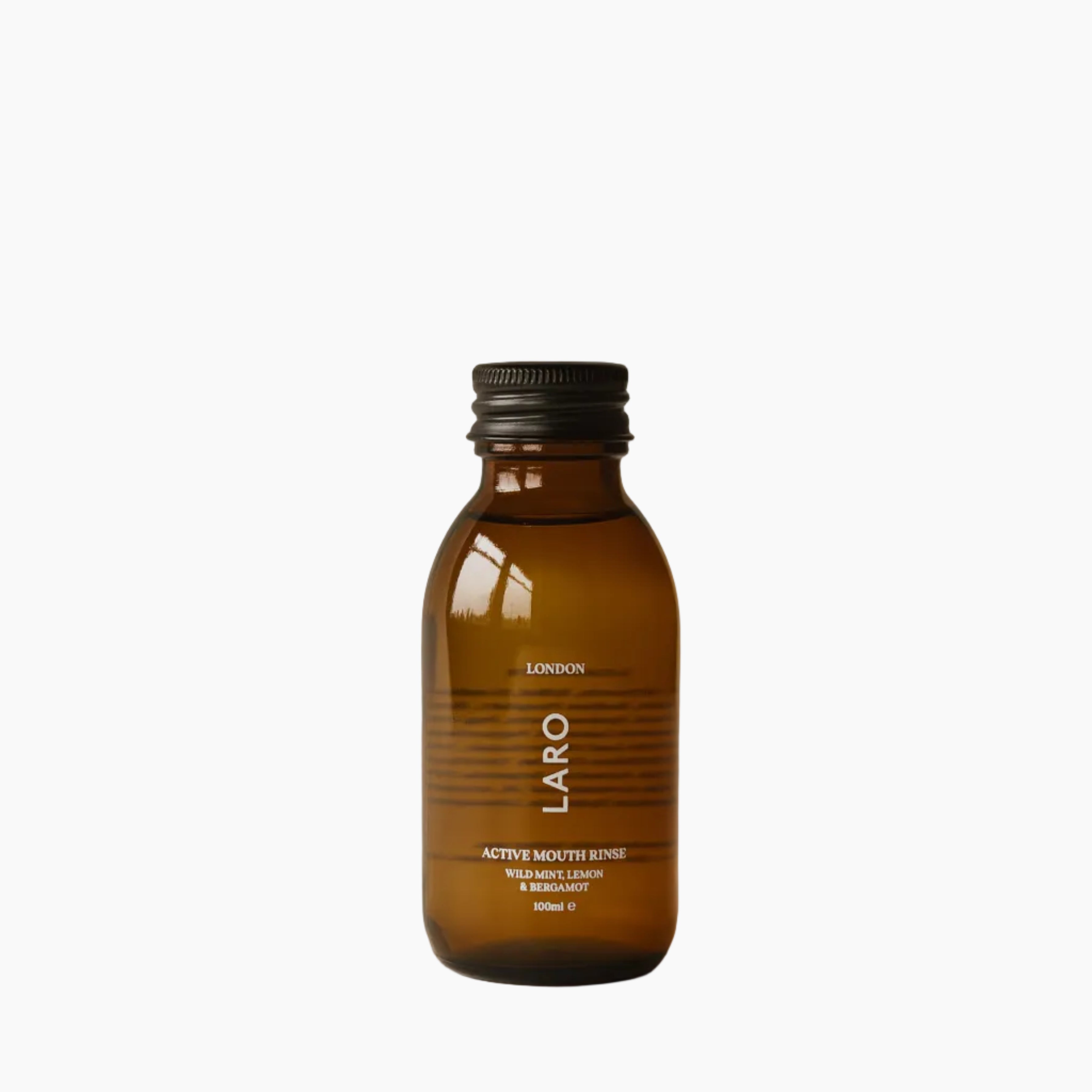 Brown travel mouth rinse bottle with black cap on a beige background