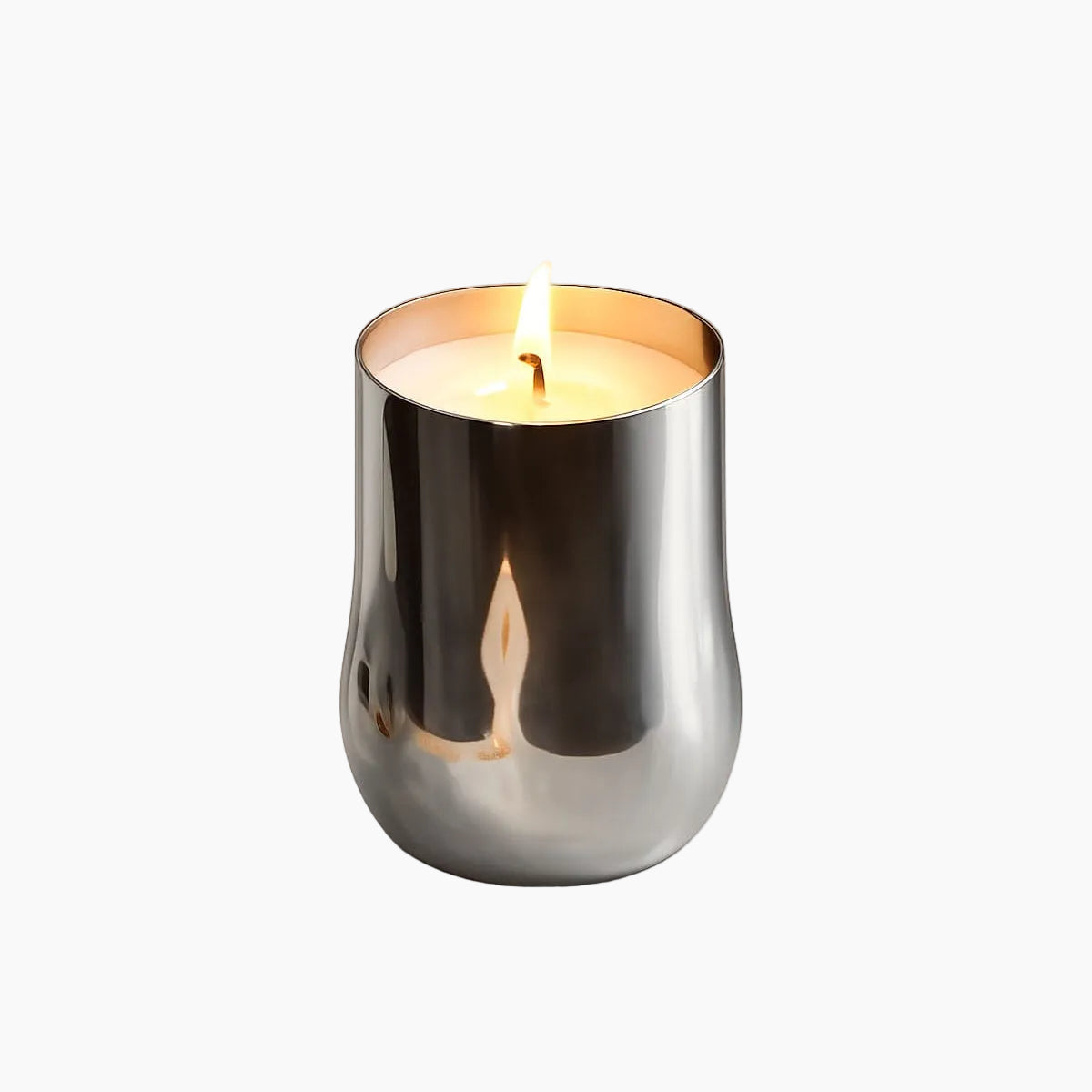 Candle in a silver holder on a beige background