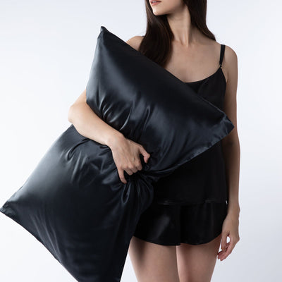 lady holding black silk pillowcase