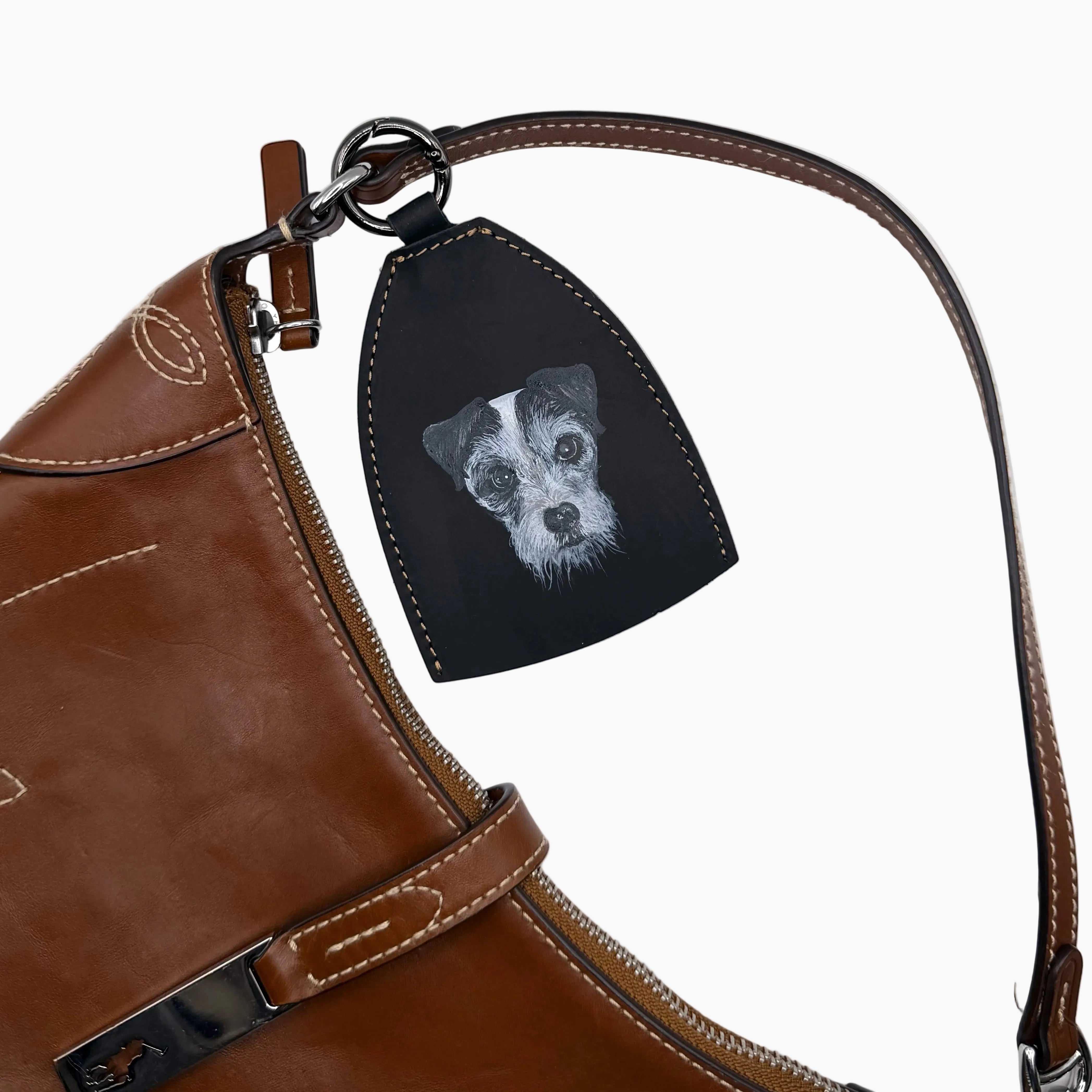 Brown leather boot with a black patch featuring a dog&