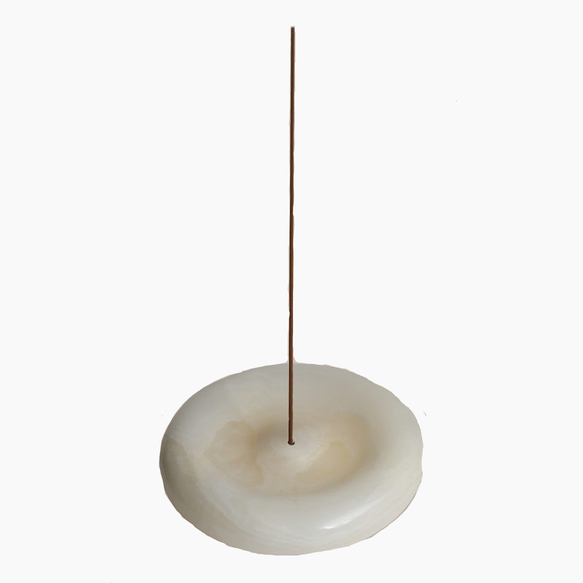 Incense burner with a single incense stick on a beige background