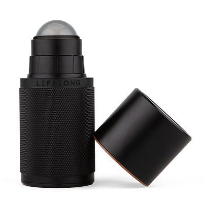Black-coloured refillable deodorant with lid off. It has knurled texture and a Lifelong logo in the middle. The lid has discrete bronze details. 