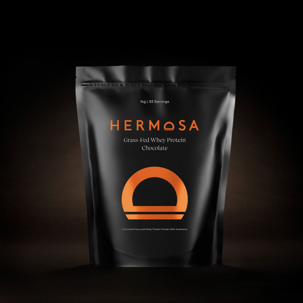 Hermosa Grass Fed Whey Protein Chocolate package on a dark background