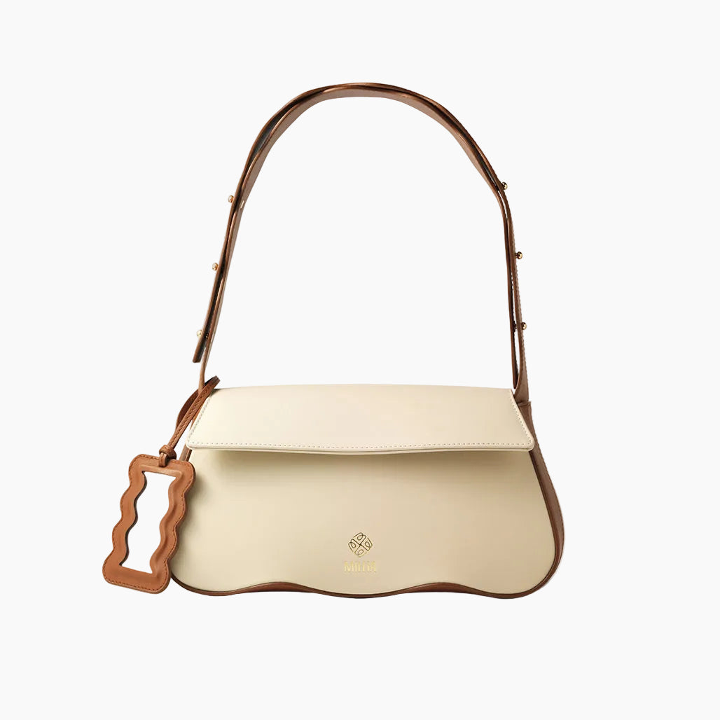 Beige handbag with brown handle on a white background