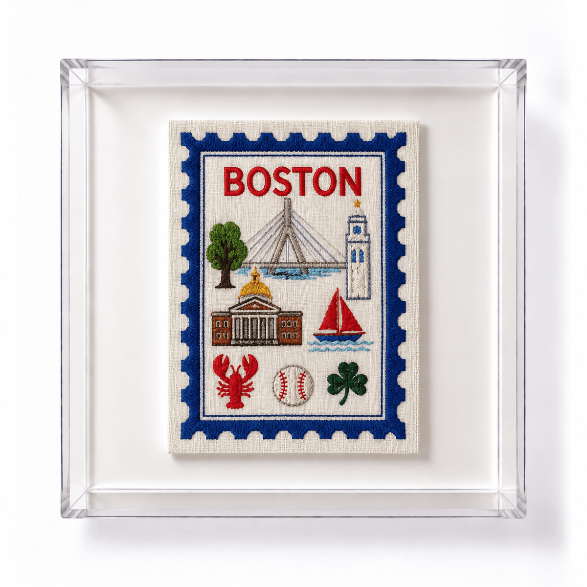 A framed embroidered Boston-themed patch or artwork with a blue border, red &