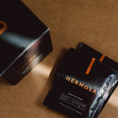 HERMOSA grass fed whey protein sachets in a pile in vanilla flavour