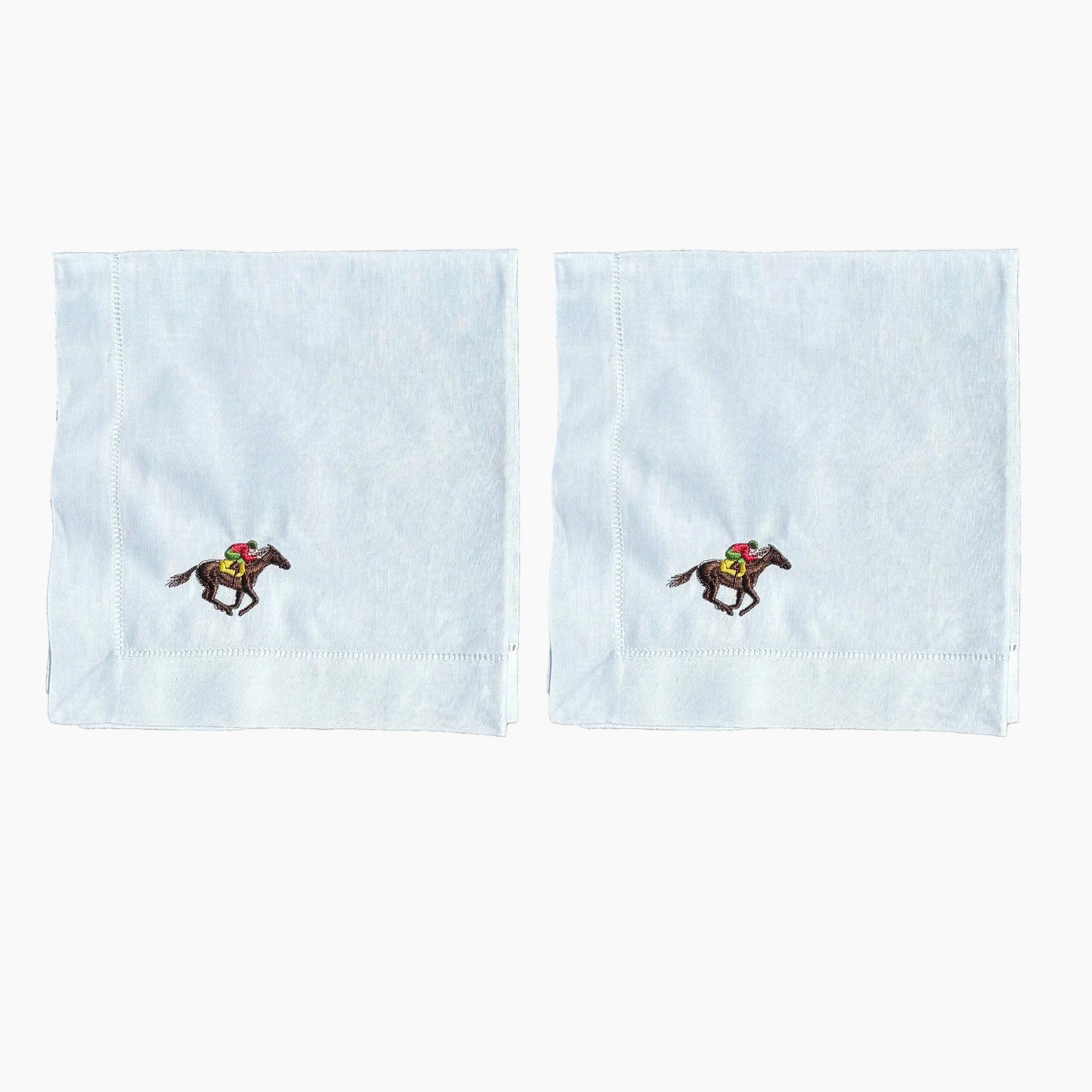 Two white handkerchiefs with embroidered horse designs on a white background
