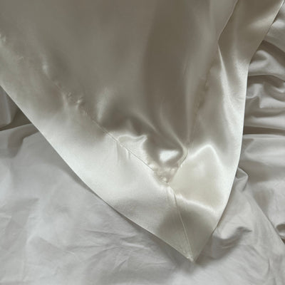 Close-up of Oxford border detailing on ivory 100% mulberry silk pillowcase – Silk Works London luxury bedding