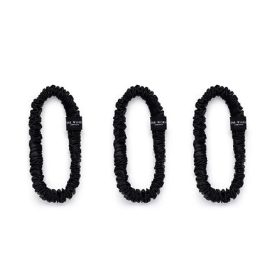 Trio of black 100% mulberry silk skinny scrunchies by Silk Works, designed to reduce breakage and frizz.