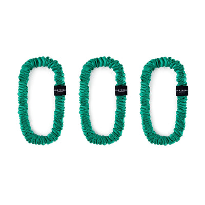 Trio of jade green 100% mulberry silk skinny scrunchies by Silk Works London, designed to reduce hair breakage and frizz.