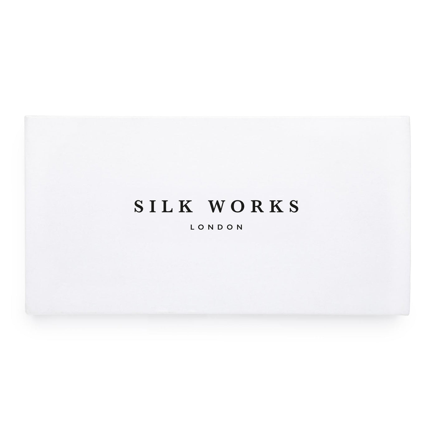 Silk Works London white luxury gift box with black logo, ideal for presenting silk sleep and self-care accessories.