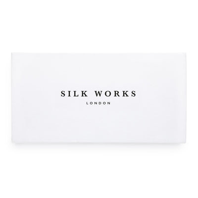 Silk Works London white luxury gift box with black logo, ideal for presenting silk sleep and self-care accessories.